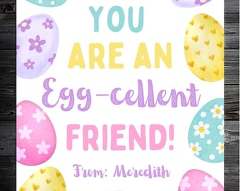 May include: A greeting card with a dark wood background features colorful Easter eggs and the text "YOU ARE AN Egg-cellent FRIEND!" in pastel colors. The card is signed "From: Meredith".