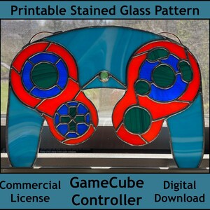 May include: A stained glass pattern of a GameCube controller. The controller is blue, red, and green. The pattern is printable and available for commercial use.