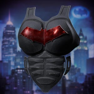 May include: Black superhero chest armour with a red bat symbol on the chest. The armour has a textured surface and is designed to protect the upper body. The background features a cityscape with a Batman symbol.