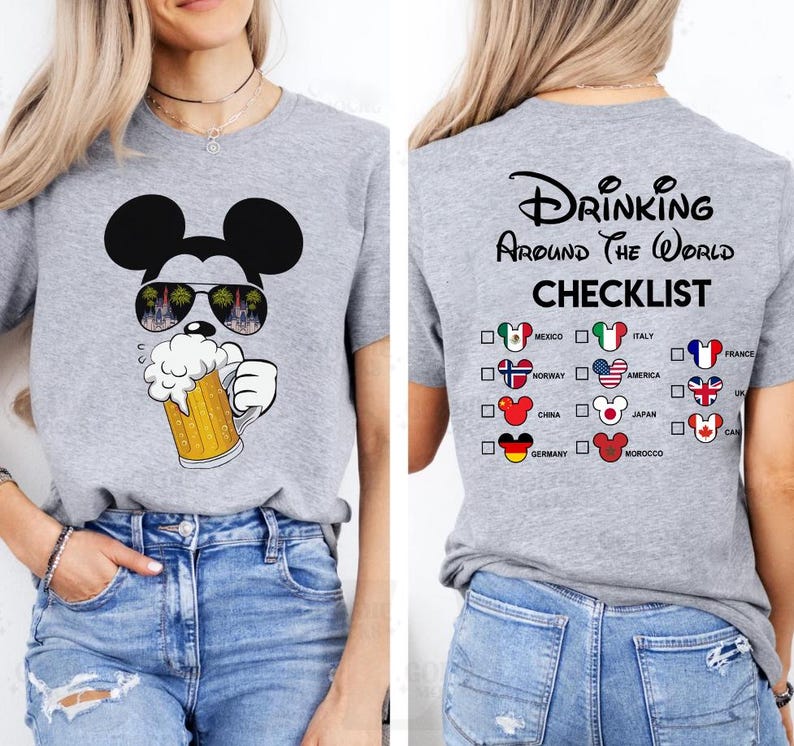 May include: A heather gray t-shirt featuring a Mickey Mouse graphic wearing sunglasses and holding a beer stein. The back of the shirt displays the text "Drinking Around The World Checklist" with country flags.