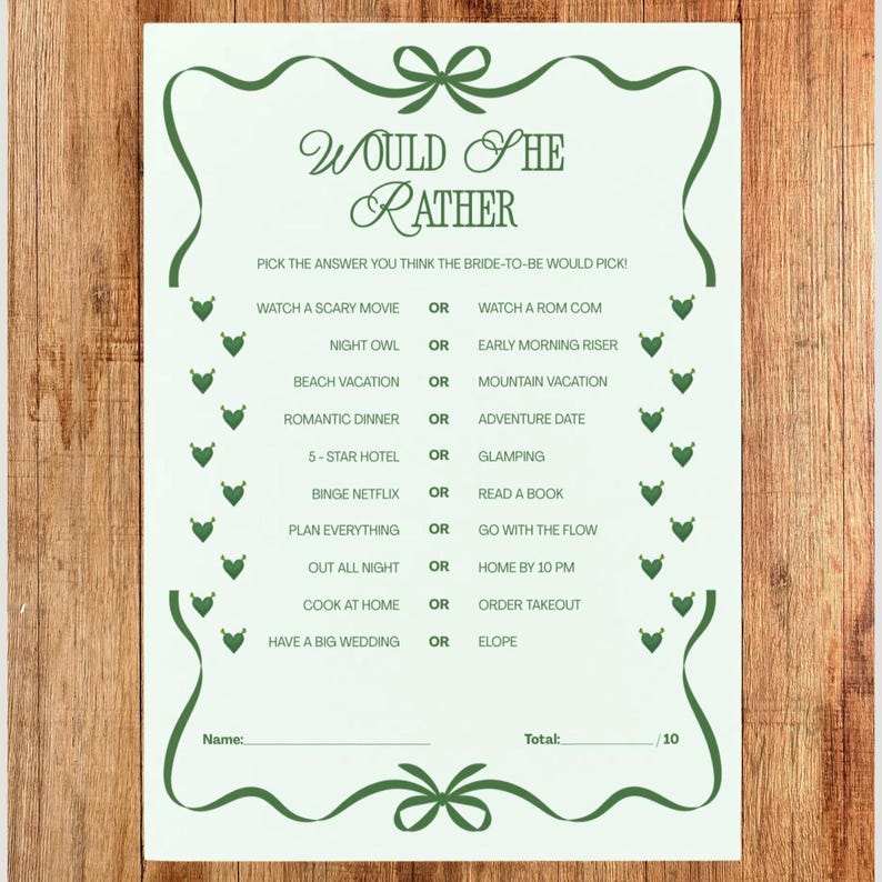 May include: A white paper game card with green decorative elements and text. The card reads "Would She Rather" and includes a series of questions for a bridal shower game. The card is framed with green bows and decorative elements.