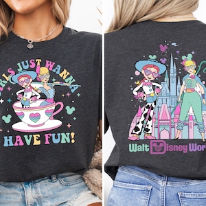 a woman wearing a black shirt with cartoon characters on it