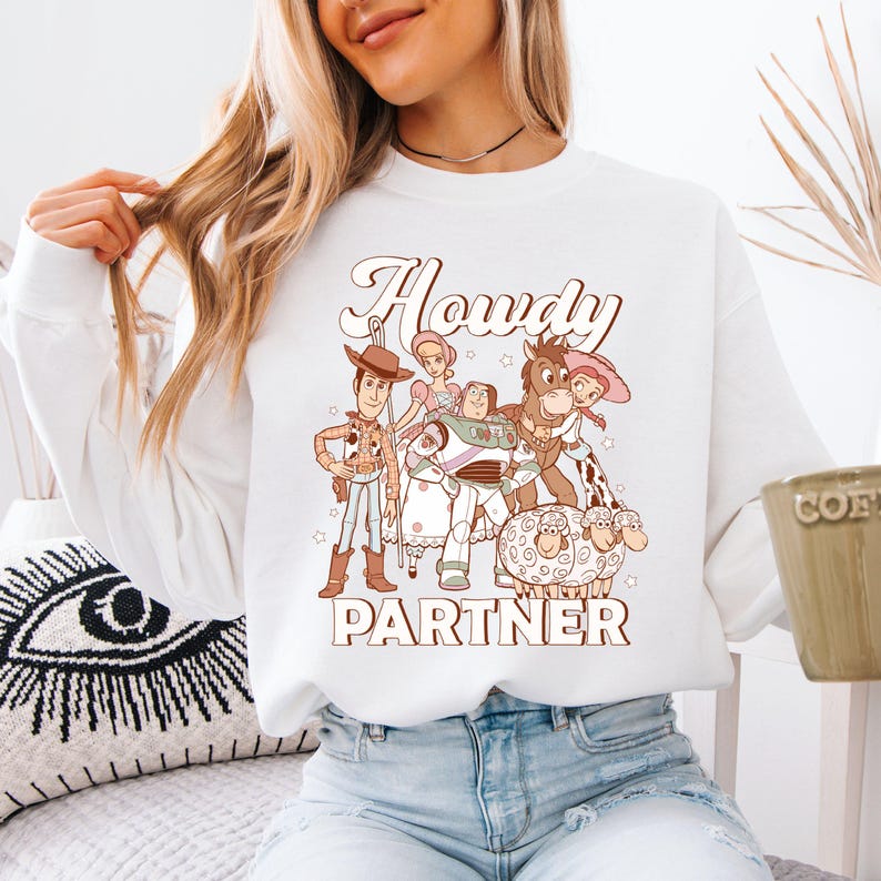 a woman wearing a white shirt with cartoon characters on it