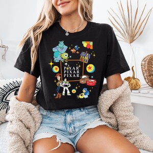 a woman sitting on a bed wearing a black shirt