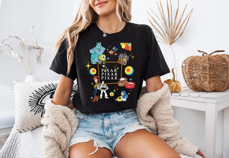 a woman sitting on a bed wearing a black shirt