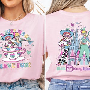 a woman wearing a pink shirt with a picture of a cartoon character on it