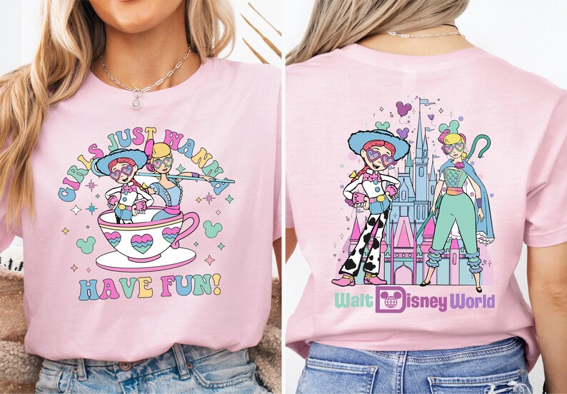 a woman wearing a pink shirt with a picture of a cartoon character on it