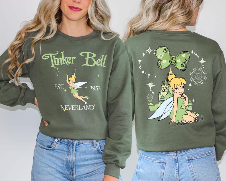 a woman wearing a green tinker bell sweatshirt