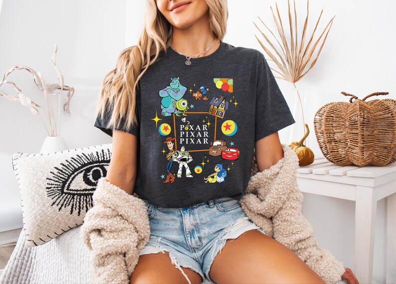 a woman sitting on a bed wearing a black shirt