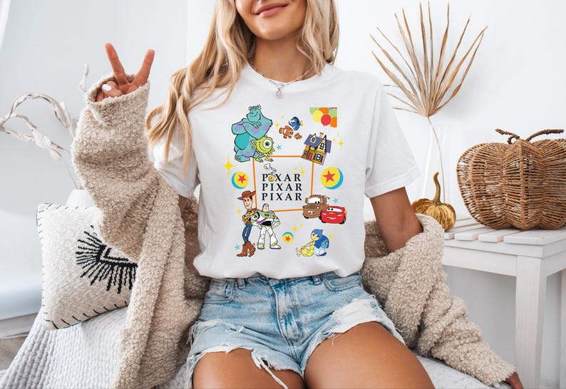 a woman sitting on a bed with her peace sign