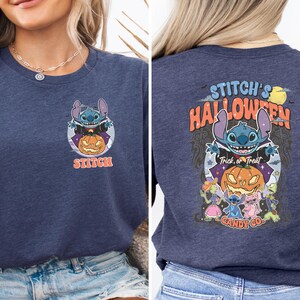 a woman wearing a halloween t - shirt and denim shorts