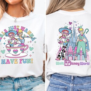 a woman wearing a white shirt with a picture of a cartoon character on it