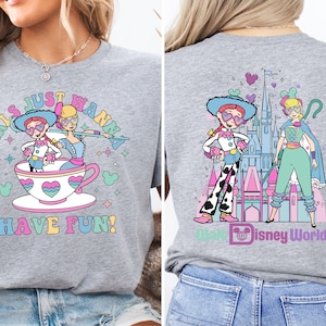 a woman wearing a gray shirt with a cartoon character on it