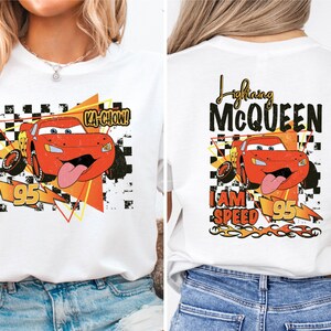 a woman wearing a t - shirt with an image of a cartoon character on it