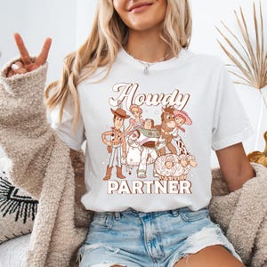 a woman sitting on a couch wearing a white shirt