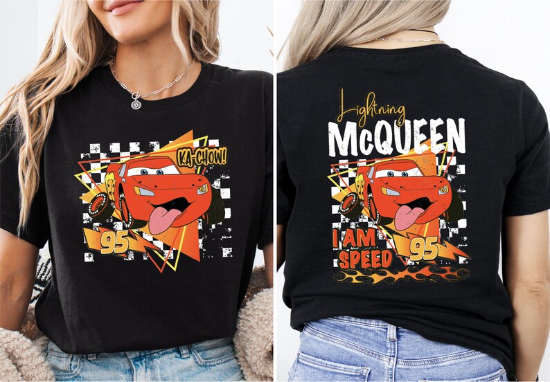 a woman wearing a black t - shirt with a cartoon character on it