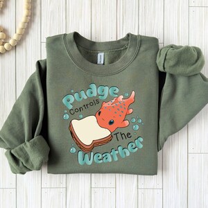 a green sweatshirt with a picture of a fish on it