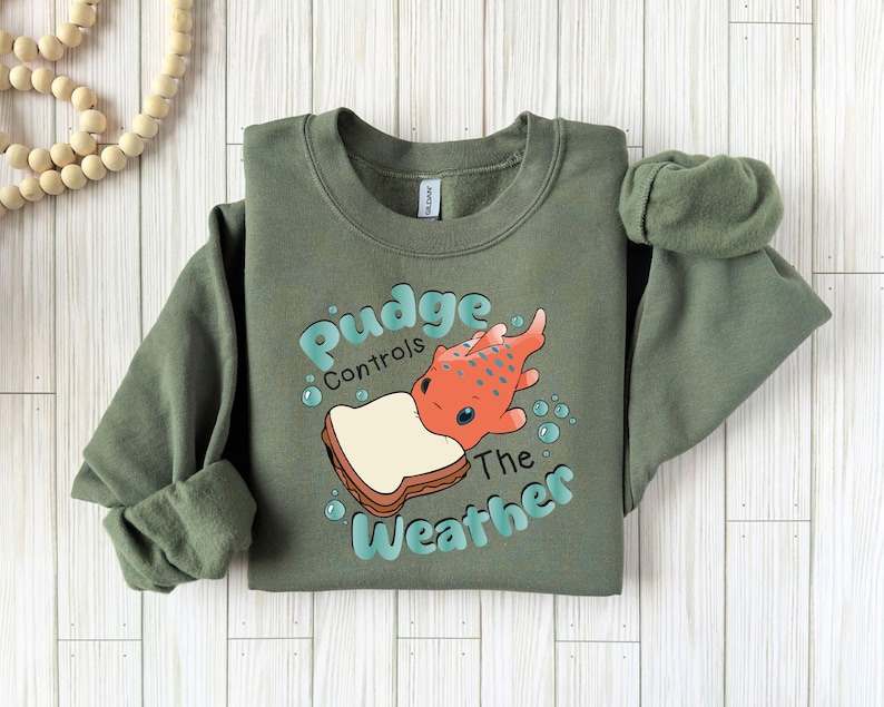 a green sweatshirt with a picture of a fish on it