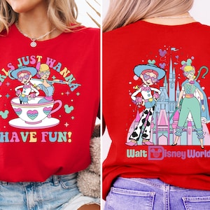 a woman wearing a red shirt with cartoon characters on it