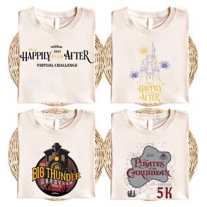 May include: Four cream-colored t-shirts with different designs. One shirt has the text "Happily Ever After Virtual Challenge". Another features a castle and fireworks. A third shirt displays a train and the words "Big Thunder Mountain". The last shirt has a map and the words "Pirates of the Caribbean 5K".