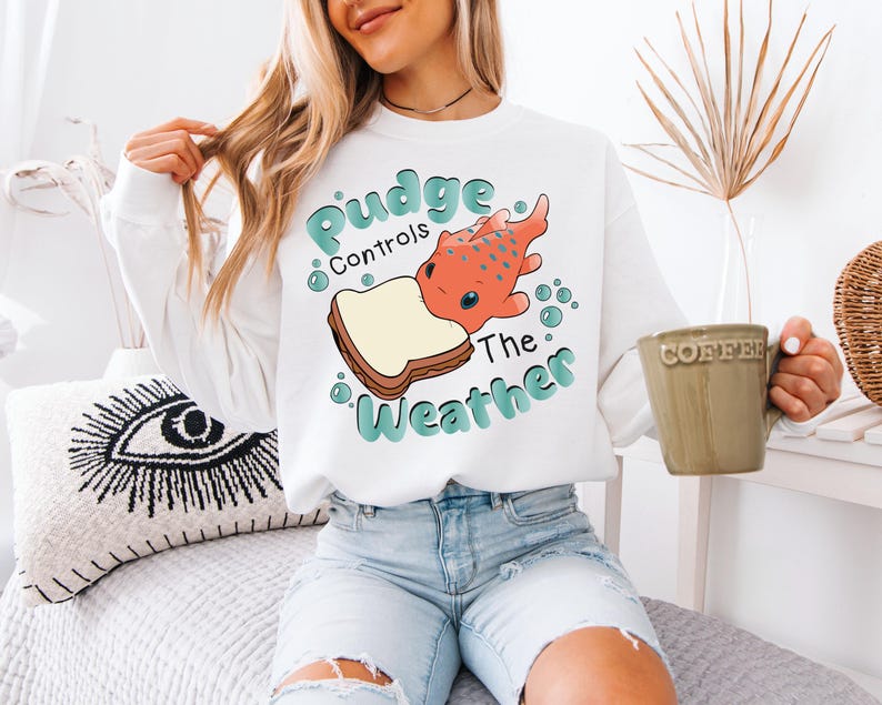 a woman sitting on a bed holding a cup of coffee