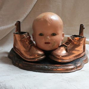Creepy Doll Head  Halloween Decoration, Upcycled Doll Head, Bronze Baby Shoe,  Blinky eyes, teeth in mouth, antique doll head