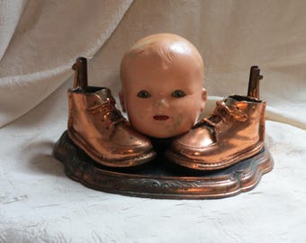 Creepy Doll Head  Halloween Decoration, Upcycled Doll Head, Bronze Baby Shoe,  Blinky eyes, teeth in mouth, antique doll head