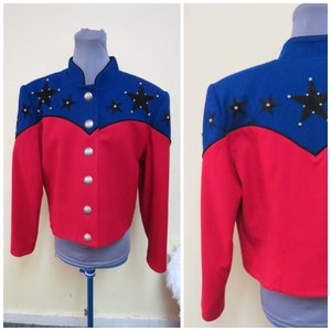 May include: A red and blue jacket with black star embellishments. The jacket has a mandarin collar and a button front closure.