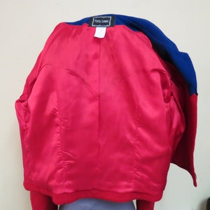 May include: A red and blue blazer with a satin lining. The blazer has a label that reads "Patty Leans".