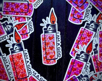 May include: A collection of stickers featuring a lighter design. The lighters have a red glitter base with heart accents and a flame. The text "I AM A GOD" is printed on the stickers.
