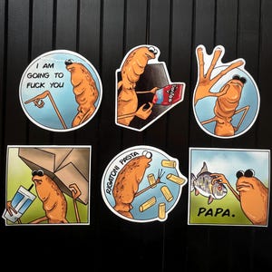 May include: A collection of six humorous stickers featuring a cartoonish, orange creature in various poses. The stickers include text such as "I AM GOING TO FUCK YOU," "Doritos," and "PAPA."