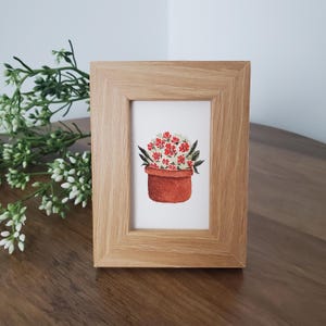 May include: A set of three ceramic mugs with a speckled, matte finish. The mugs are in shades of cream, light gray, and dark gray. Each mug has a simple, minimalist design, perfect for coffee or tea.