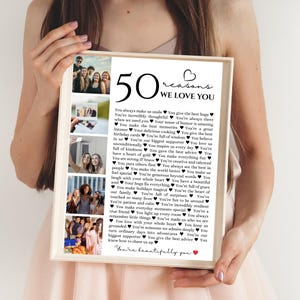 May include: A framed print with the text "50 reasons we love you" and a list of reasons. The print includes several small photos of people. The words "You're beautifully you" are at the bottom.