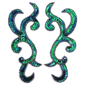 May include: Two green and blue iridescent sequined embellishments in a floral design.
