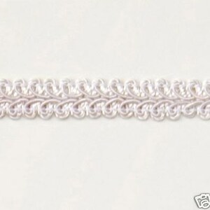 May include: White braided trim with a decorative, looped pattern. This trim is perfect for adding a touch of elegance to any project.