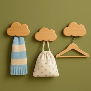 May include: Three wooden cloud-shaped wall hooks. One hook holds a blue and cream striped knit hat. Another holds a white drawstring bag with blue polka dots. The third hook holds a wooden clothes hanger.