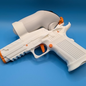 May include: A white and orange toy gun with a gray object on top. The toy gun has detailed features, including an orange trigger and accents. The background is a solid blue.