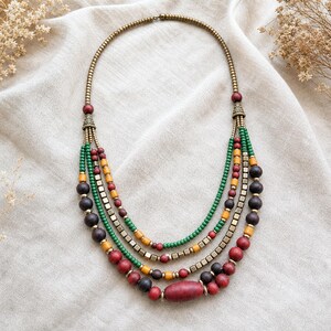 Rose Gold and Silver Statement Beaded Necklace presented in an open jewelry gift box on natural linen