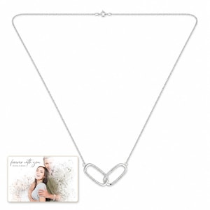 Everlinked Sterling Necklace shown during a believable gift-giving moment between adults with the exact jewelry visible.