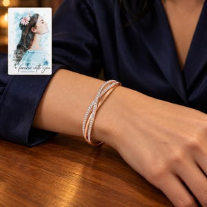 Crossover Bangle Bracelet, worn with evening clothing. A sample personalized digital greeting card is shown alongside.