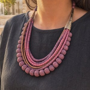 Three-piece handmade necklace set featuring rose gold and brown beaded necklace, rose gold and brown beaded necklace and rose gold and brown beaded necklace, displayed together to show the coordinated colors and beadwork