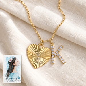 K Initial Heart Necklace, linen flatlay view. A personalized digital greeting card is shown alongside.