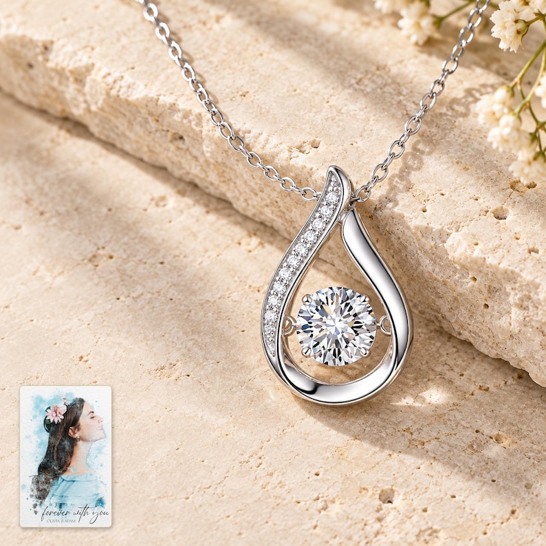 Moissanite Teardrop Necklace, shown on a display surface. A sample personalized digital greeting card is shown alongside.