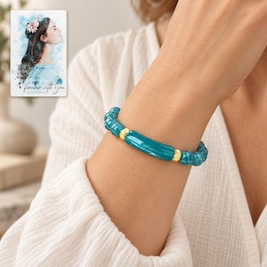 Peacock Tide Bar Bracelet worn by an adult model for styling and everyday styling. A personalized digital greeting card is shown alongside.