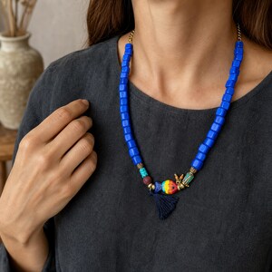 Three-piece handmade necklace set featuring blue and clear beaded necklace, rose gold and gray beaded necklace and brown and silver beaded necklace, displayed together to show the coordinated colors and beadwork