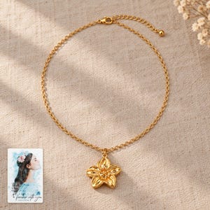 Gold Tone Flower Necklace, laid on fabric. A sample personalized digital greeting card is shown alongside.