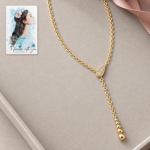 Moissanite Y Necklace, evening style view. A personalized digital greeting card is shown alongside.