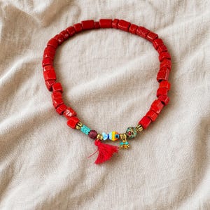 Gift ready presentation of Red and Brown Statement Beaded Necklace in an open jewelry box lined with natural ivory linen