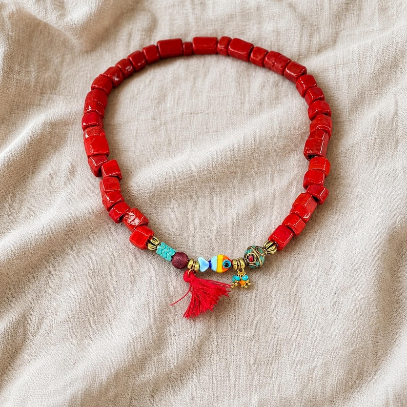 Gift ready presentation of Red and Brown Statement Beaded Necklace in an open jewelry box lined with natural ivory linen