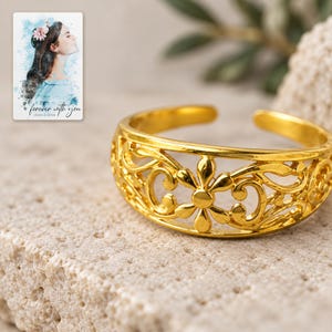 Golden Bloom Filigree Ring shown in a close macro view highlighting the visible texture, texture and construction details. A personalized digital greeting card is shown alongside.